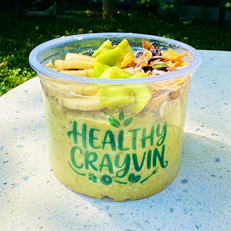 Avocado Banana Podda size in a Healthy Crayvin cup, topped with banana, avocado and granola