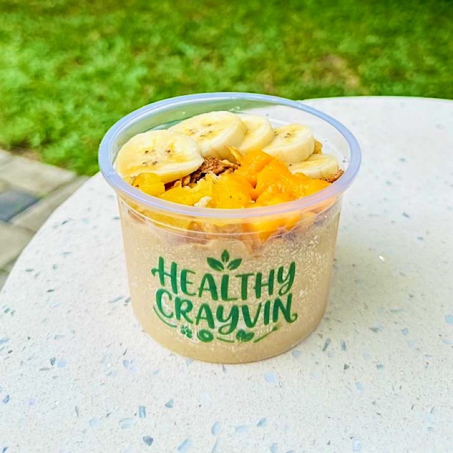 Sunshine Podda size in a small Healthy Crayvin cup, topped with banana slices, mango and granola